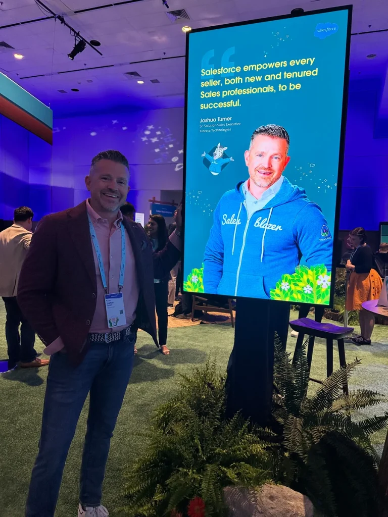 Josh next to his feature on a Salesblazer poster