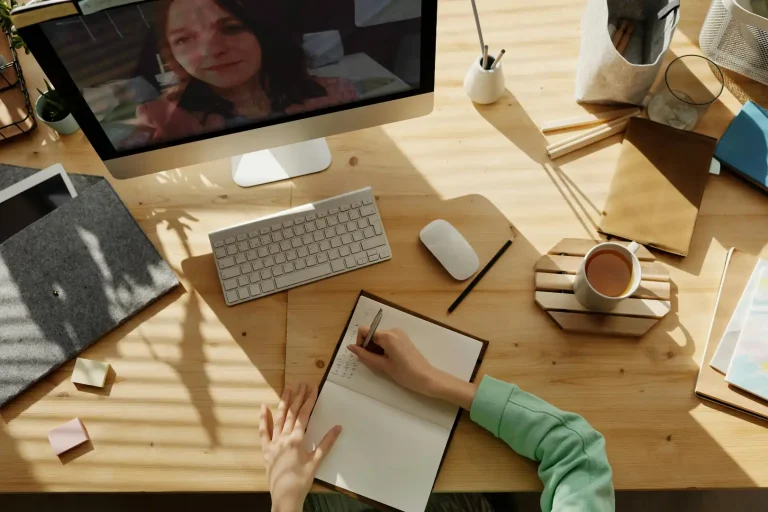 Video call with hands taking notes